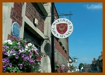 Hanging baskets and Museum sign